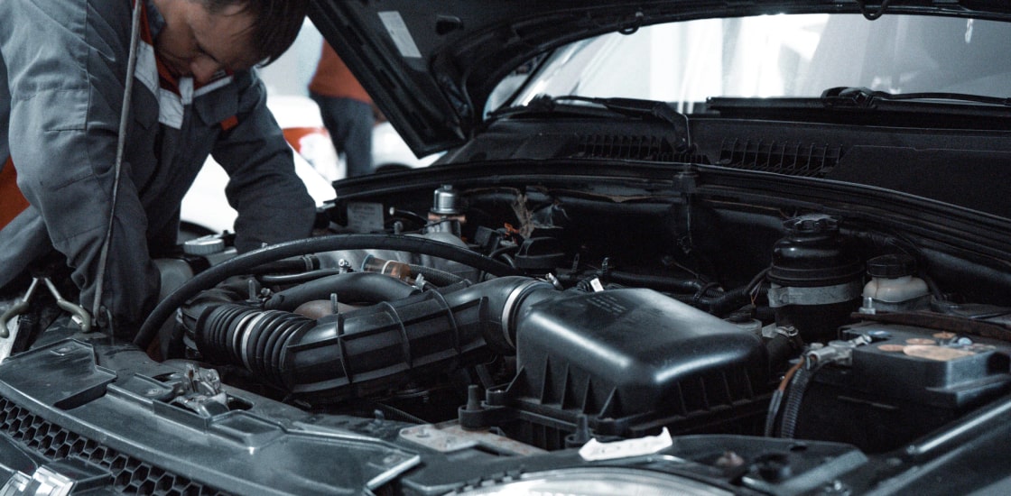Man repairing a car motor