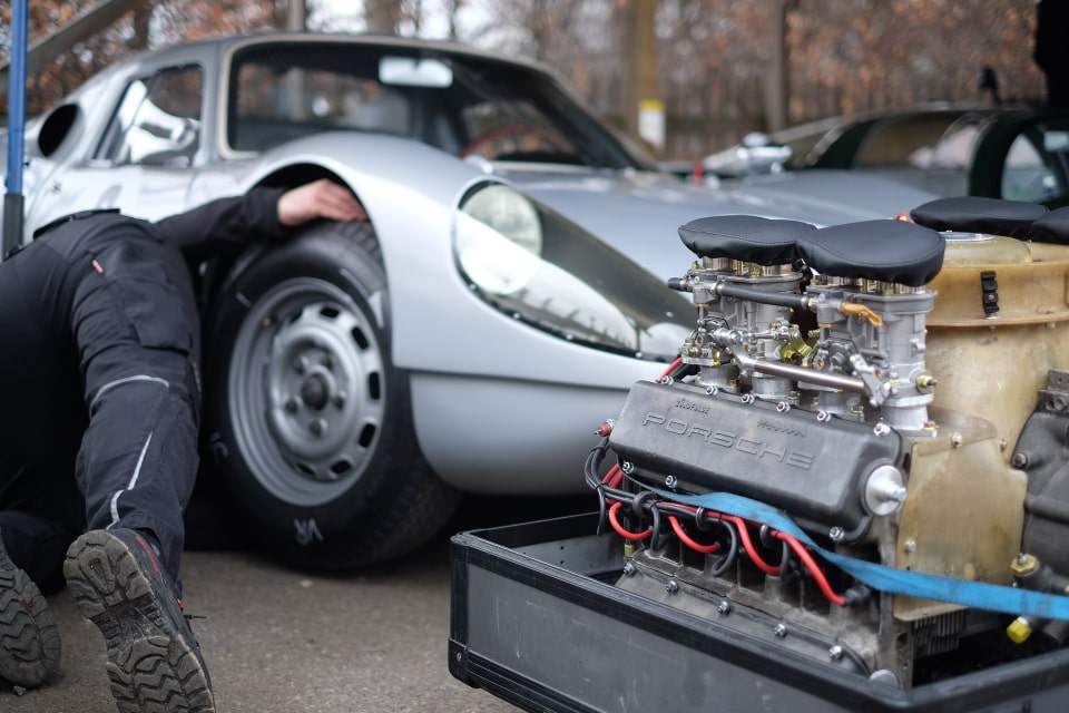 Technician inspecting a car